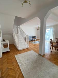 una sala de estar con una escalera blanca en una casa en Downtown House with garden, en Sarajevo