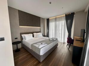 a hotel room with a bed and a television at Frojd Kune Resort & Beach Hotel in Shëngjin +142 photos