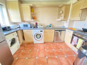 a kitchen with a washing machine and a washer at Sweet home 2 Double bedrooms apartment free parking Summertown, Oxford in Oxford