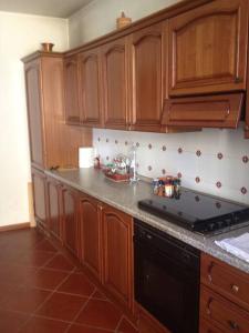 Camino的住宿－Charming Villa in Monferrato，厨房配有木制橱柜和炉灶烤箱。