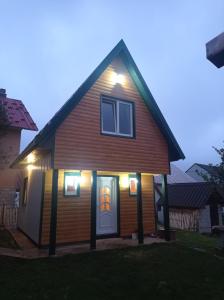 a house with lights on the front of it at Cottage Usovic in Žabljak