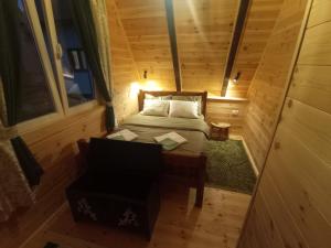 a small room with a bed and a chair at Cottage Usovic in Žabljak