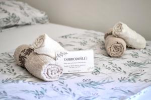 a towel animal is laying on a bed at Apartman Vas dom 2 in Kraljevo