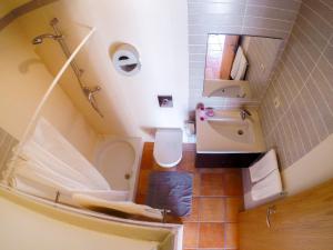 a bathroom with a sink, toilet and bathtub at Mayla Surf House in Aljezur