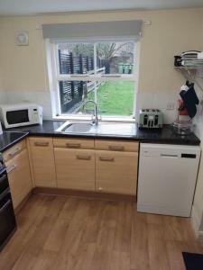 a kitchen with a sink and a window at Eden house in Appleby