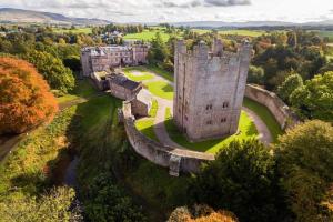 an aerial view of a castle in the countryside at Eden house in Appleby