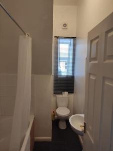 a bathroom with a white toilet and a sink at Eden house in Appleby