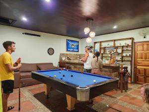 托爾圖格羅的住宿－Hostel Tortuguero 7BackPackers，一群人在客厅里,客厅里设有一张台球桌