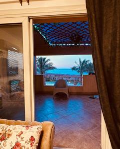 a living room with a view of the ocean at Telal Al Sukhna Only families in Ain Sokhna