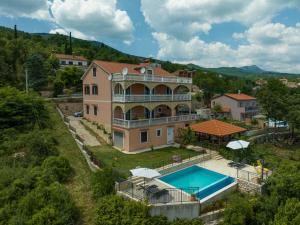 an aerial view of a house with a swimming pool at Jovich Apartments 3 in Mošćenička Draga