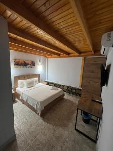 a bedroom with a bed and a wooden ceiling at Ados Hotel in Cesme