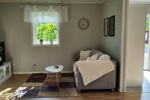 a living room with a couch and a table at Gästhus nära naturen in Holmsund