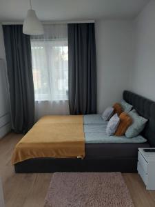 a bedroom with a bed with a teddy bear on it at Apartament Świerkowa in Lidzbark