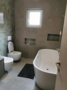 a bathroom with two sinks and a tub and a toilet at Lunisa VS1 Apartment in Kostrena