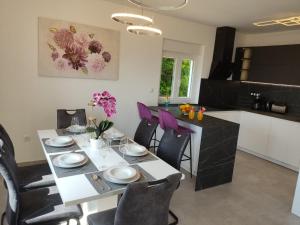 a kitchen and dining room with a table and chairs at Lunisa VS1 Apartment in Kostrena