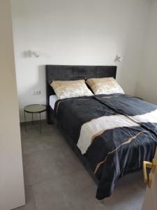 a bedroom with a large bed and a table at Lunisa VS1 Apartment in Kostrena +18 photos