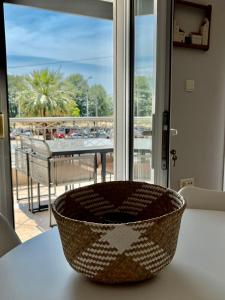 a basket sitting on a table in front of a window at Casita Dos in Ofrínion