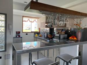 a kitchen with a counter with stools in it at Mviajes Travel & Services in Cajamarca
