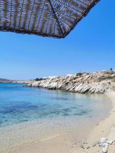 a view of a beach with the ocean at Two level house on the Beach in Agios Ioannis Mykonos