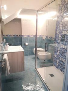 a bathroom with a shower and a sink and a toilet at Villa Furoris Apartment in Furore