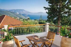 a table and chairs on a balcony with a view at Pithari Stone Villa in Khalikerí