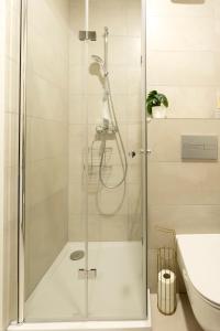 a shower with a glass door in a bathroom at Apartman Elena Ekolu in Split