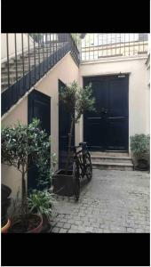 a bike parked in front of a building with a tree at Au cœur du quartier Latin in Paris