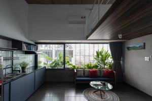 a kitchen and living room with a couch and a table at Hoa house in Ho Chi Minh City