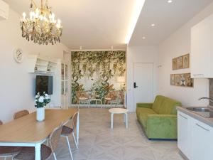 a living room with a green couch and a table at Colombo 477 Auditorium in Civitanova Marche