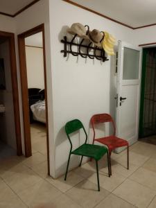 two chairs in a room next to a door at La Solita in Mercedes