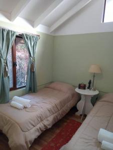 a bedroom with two beds and a window at Depto Acogedor cómodo y súper luminoso en km 7,500 in San Carlos de Bariloche