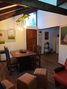 a dining room with a table and chairs at Depto Acogedor cómodo y súper luminoso en km 7,500 in San Carlos de Bariloche