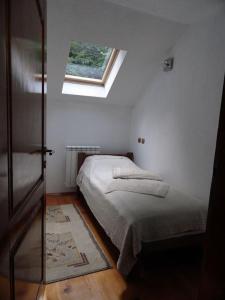 a small bedroom with a bed and a window at Weekend house Grahovača in Rožaje