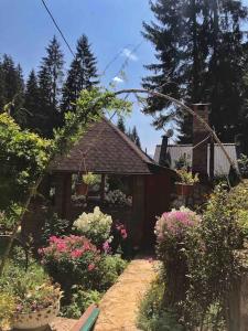 a garden with flowers in front of a house at Weekend house Grahovača in Rožaje