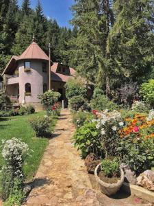 a house with a garden with flowers in front of it at Weekend house Grahovača in Rožaje