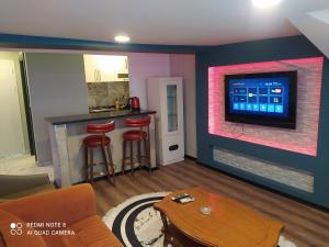 a living room with a bar and a tv at The Sweet Building Esso in Istanbul