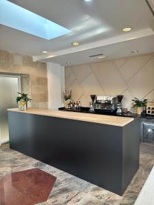 a kitchen with a black counter top in a room at Hotel Buenavista Beach House Trogir in Trogir