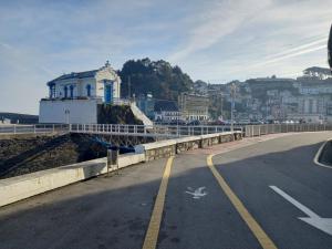 a bridge over a road with a building on it at Casa Anita in Luarca