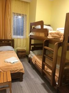 a room with two bunk beds and a window at Koticha in Borjomi