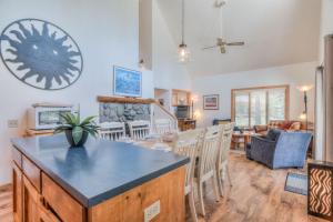 a kitchen and living room with a table and chairs at Modoc - Unit 16 in Sunriver