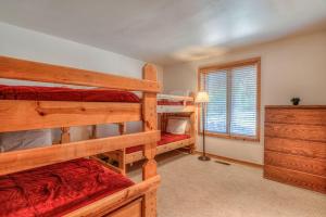 a bedroom with two bunk beds and a window at Modoc - Unit 16 in Sunriver