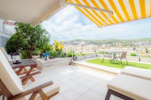 a patio with a table and chairs on a balcony at Apartment Luna Tossa De Mar 5mins walking to the beach with sea and castle view big terrace in Tossa de Mar