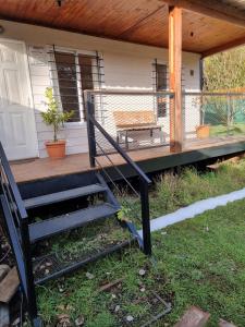 a porch with a staircase and a bench on a house at Villa Amalia in San Carlos de Bariloche