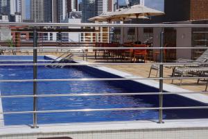 a swimming pool on the roof of a building at Flat Buenos Ayres Cabo Branco in João Pessoa