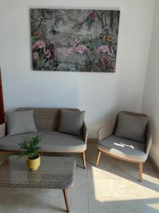 a living room with two couches and a table at Hostel Oltenia in Eforie Sud