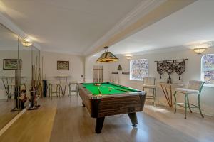 a room with a pool table and some chairs at Banyan House Vacation Rentals in Venice