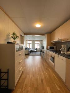 a large kitchen with wooden floors and a large room at Stylish Vintage Home in the Heart of the City in Trondheim