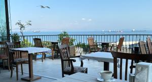 a patio with tables and chairs and a view of the ocean at Queen Seagull Boutique Hotel in Istanbul