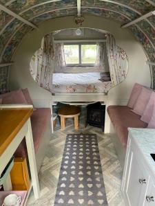 a tiny house with a bed and a window at Langtonbury in Appleby