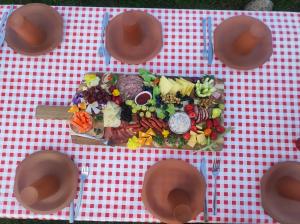 stół z talerzem żywności na czerwono-białej tkaninie stołowej w obiekcie Gniazdo w Felicjanowie w Uniejowie